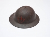 British/Canadian steel “Brodie pattern” helmet as worn by Canadian troops beginning in early 1916. Before this, soldiers wore soft fabric caps. This helmet was used by a member of the 1st Contingent