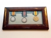 Framed set of three medals consisting of the Military Medal (for bravery in the field), British War Medal, and Victory medal