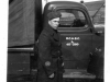 Man in Long Coat beside Truck