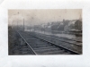 Railroad Beside a River across from Houses